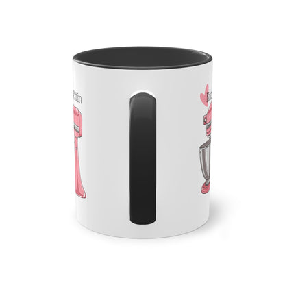 a white and black coffee mug with a black handle