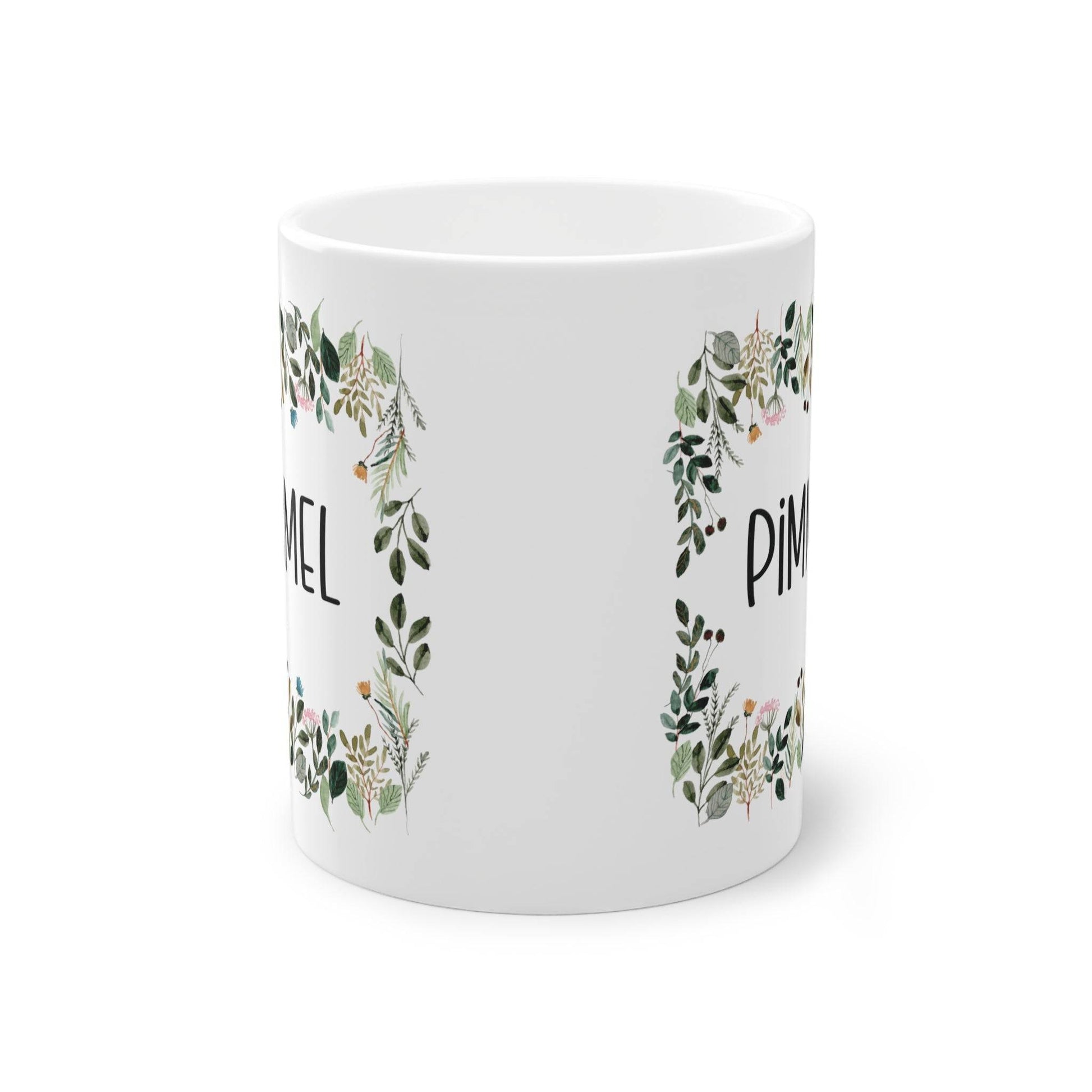 a white mug with a floral design on it