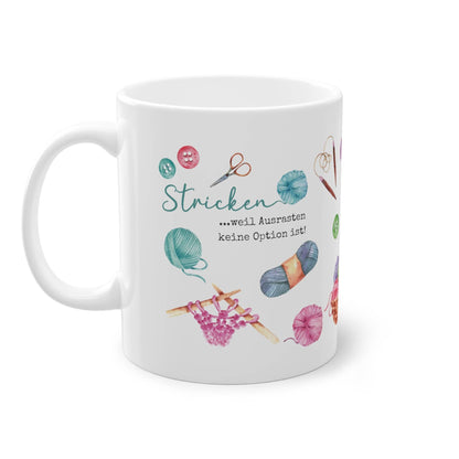 a white coffee mug with a picture of knitting items on it