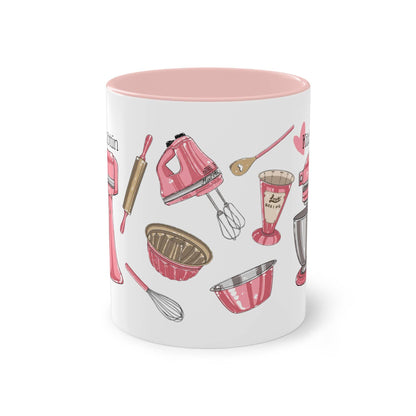 a pink and white coffee mug with kitchen utensils on it