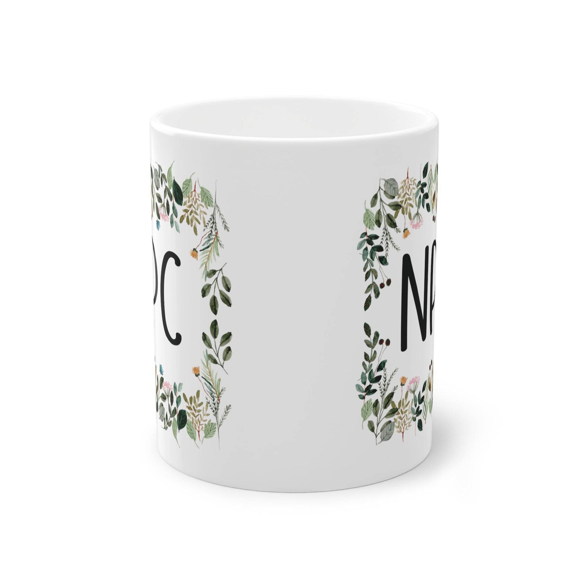 a white mug with a floral design on it