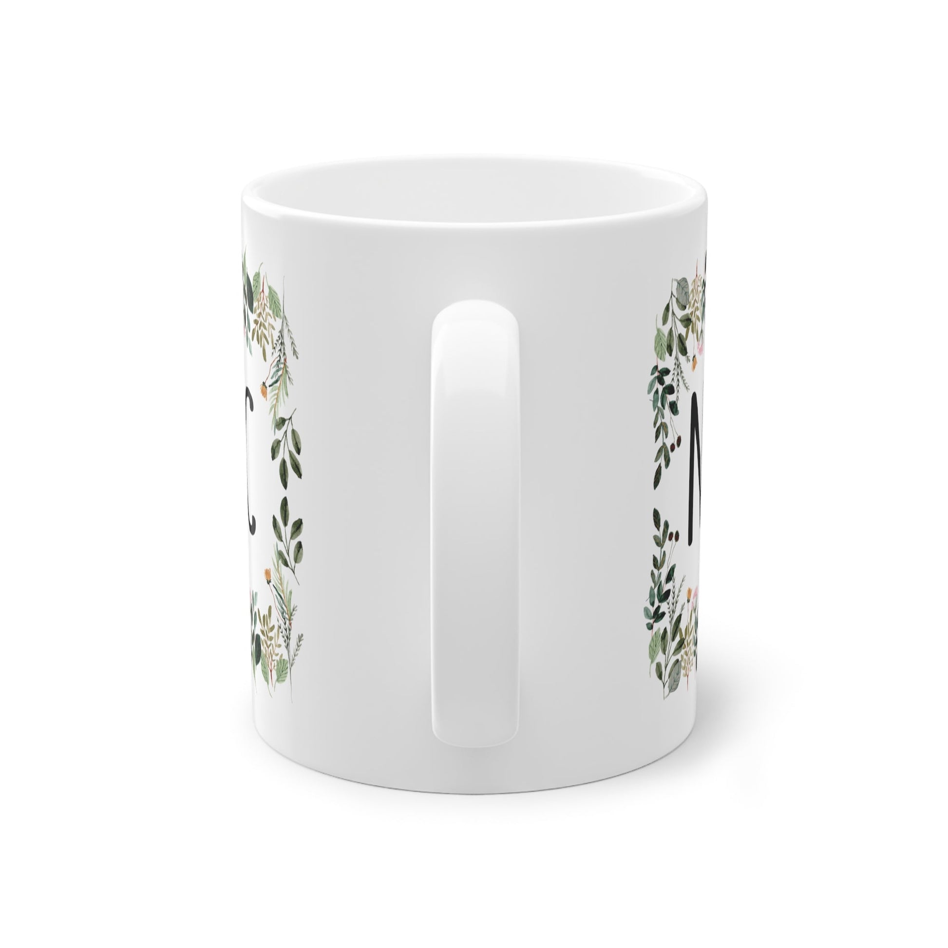 a white mug with a floral design on it