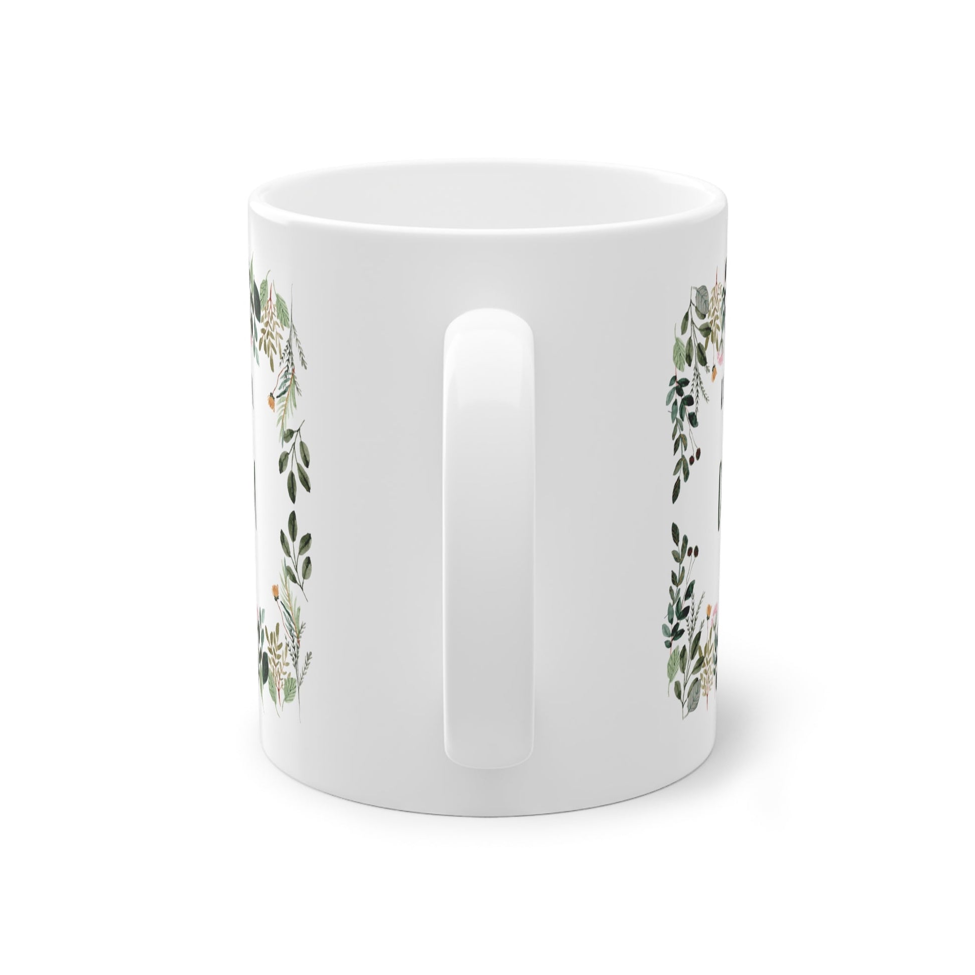 a white mug with a floral design on it