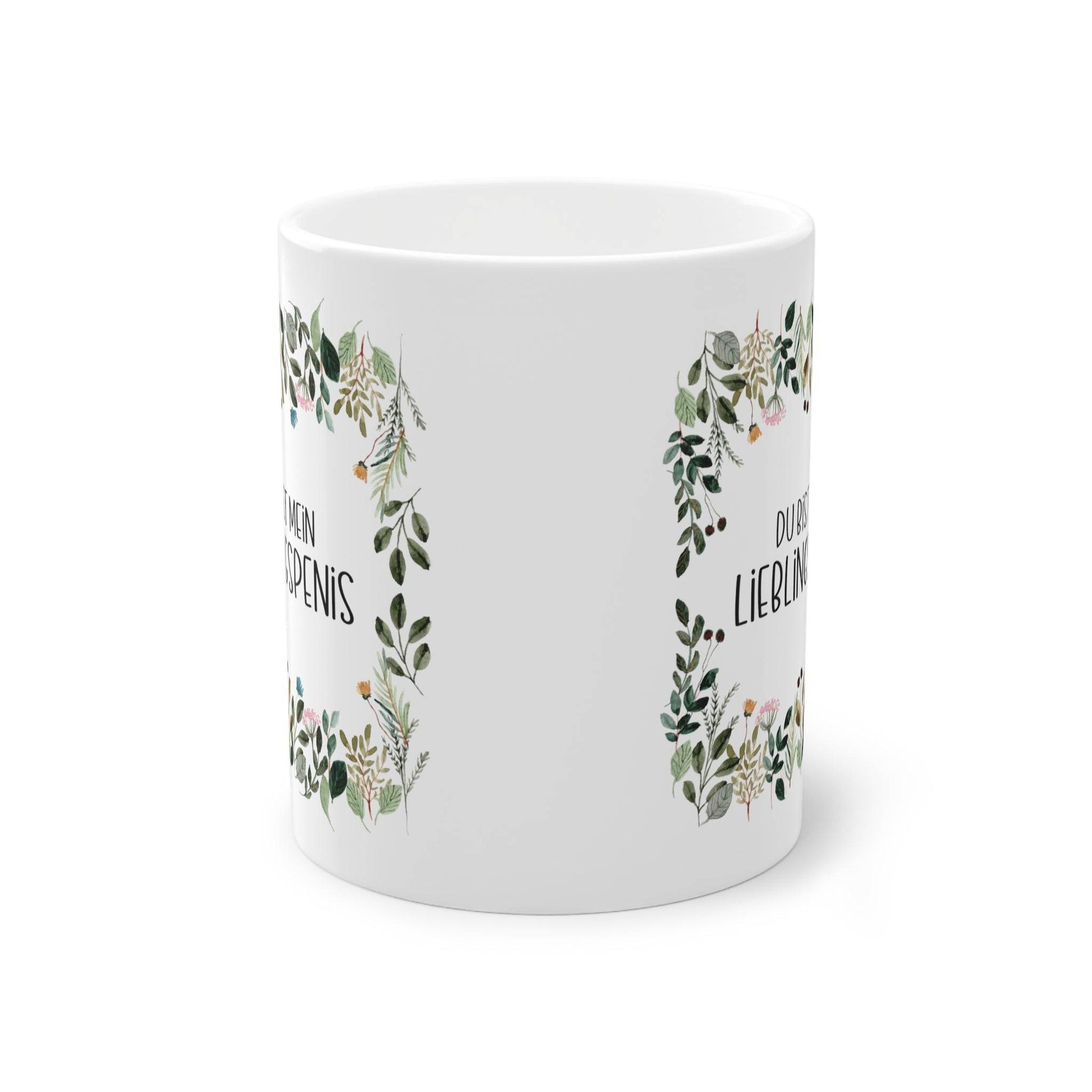 a white mug with a floral design on it